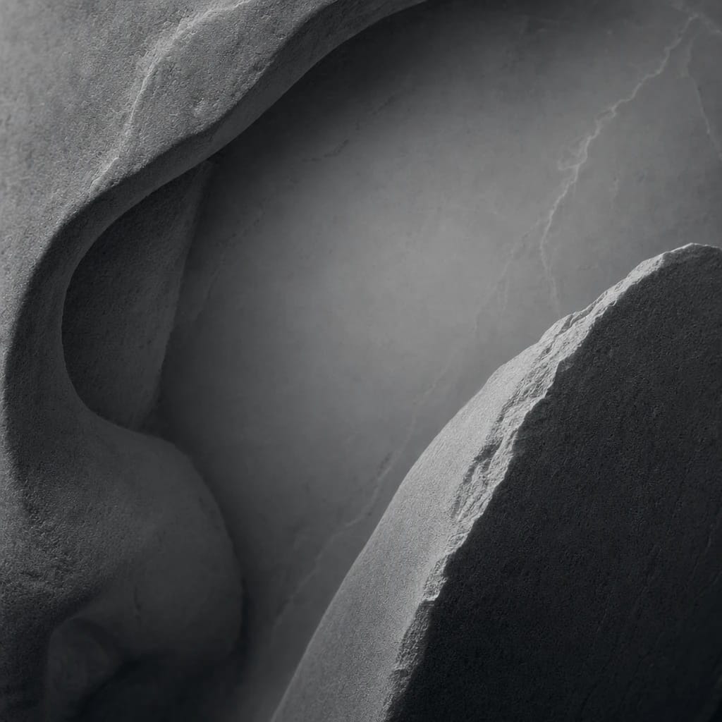 Stylized scene featuring a polished fragment of a marble bust, rendered in charcoal gray #41454A
