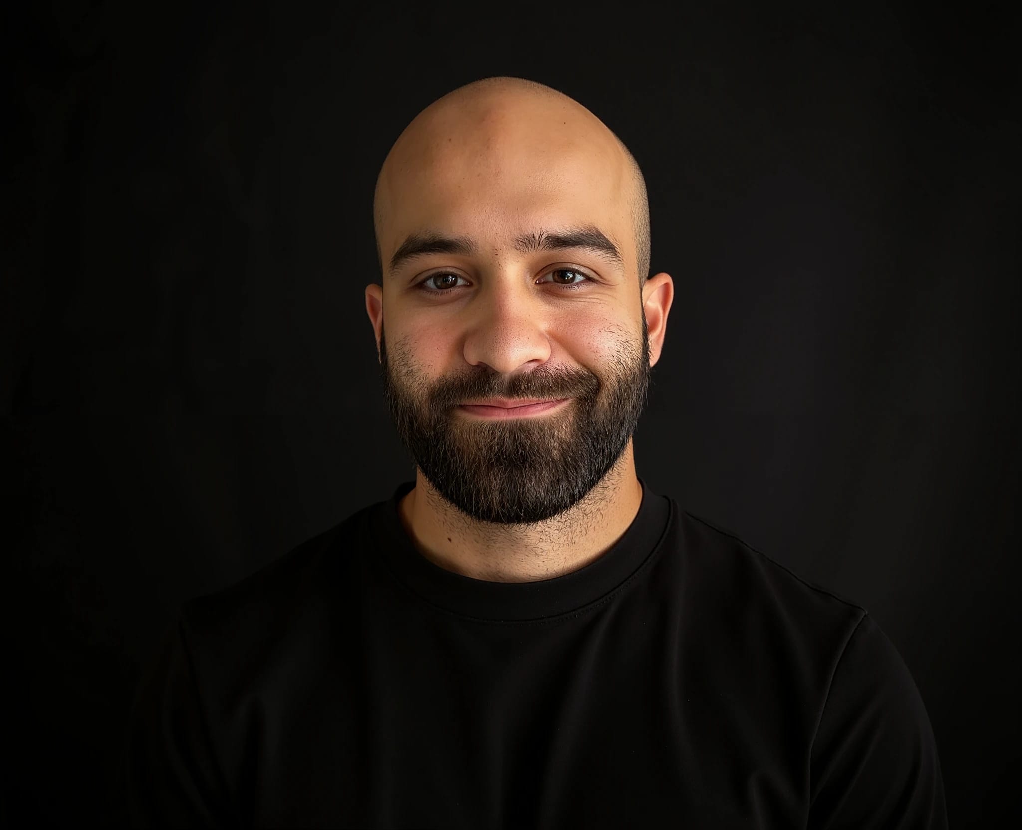 bald man with a beard smiling